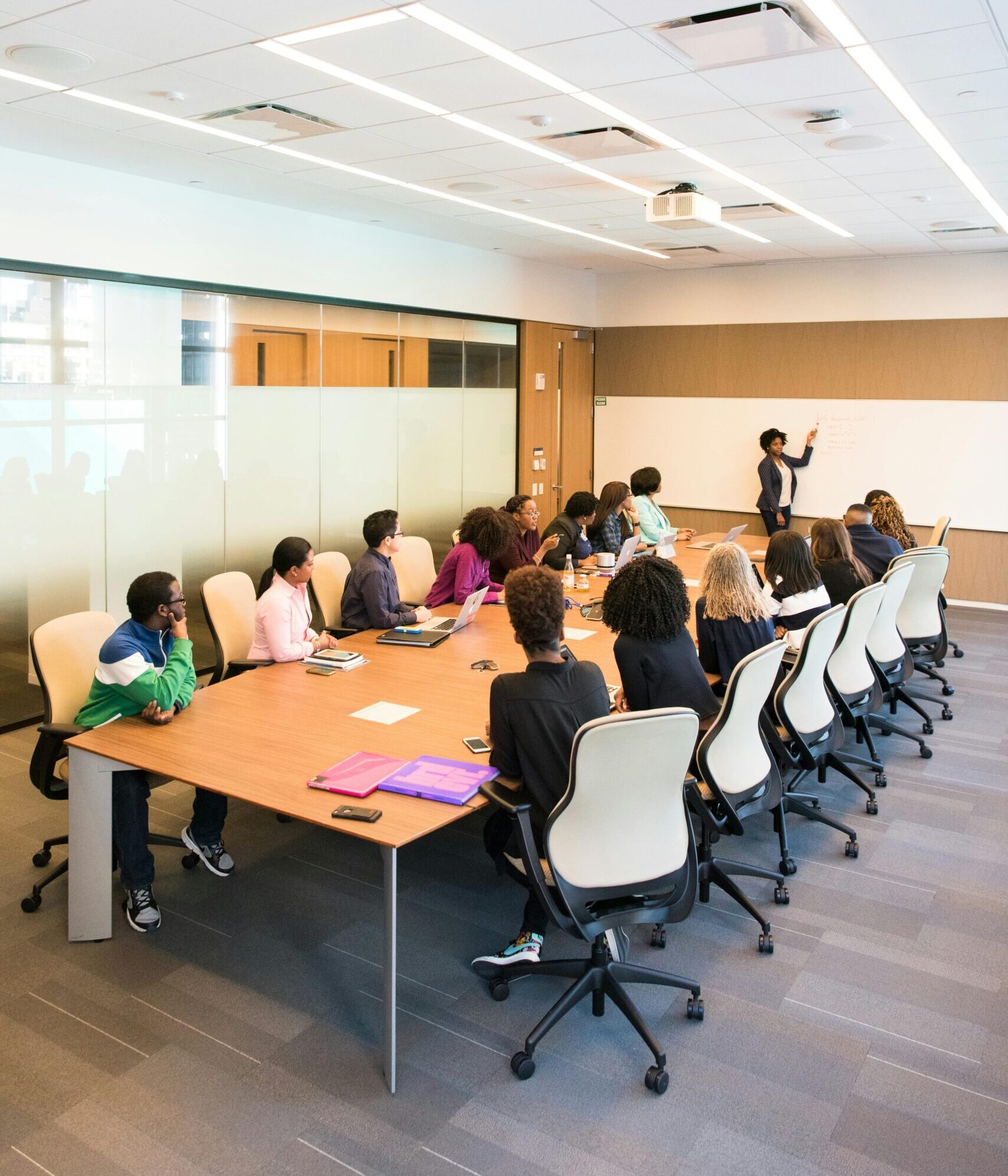 Professional team engaged in a collaborative boardroom meeting with a presentation in progress.